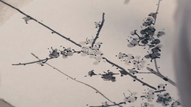 A person painting with a brush on paper