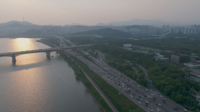 Busy Seoul road with bridge over the Han River