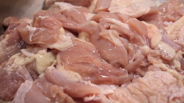 Raw chicken pieces in a metal bowl