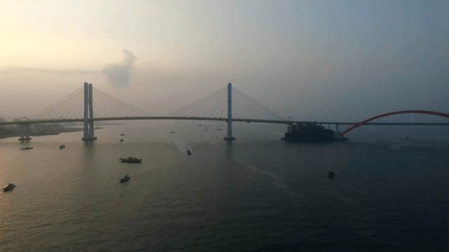 Bridge over the calm sea at sunset