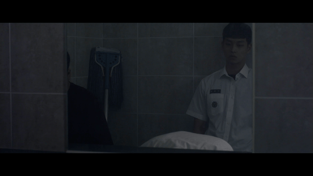 Two students in a dimly lit bathroom