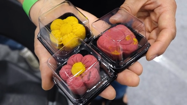 Colorful flower-shaped desserts in hands