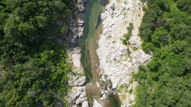 A serene river flowing through rocky terrain