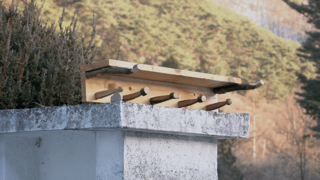 Wooden stand on a stone pillar in nature