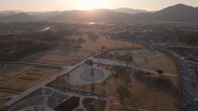 Historic site with sunset and mountains