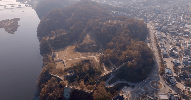 A scenic view of a historic site and river