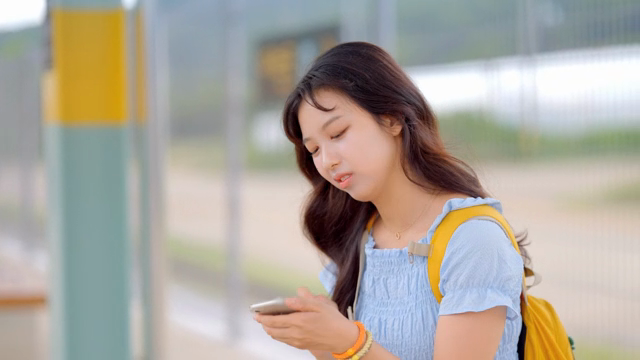 Tired woman greeting friend at train station