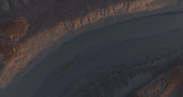 Aerial view of a winding river at dusk