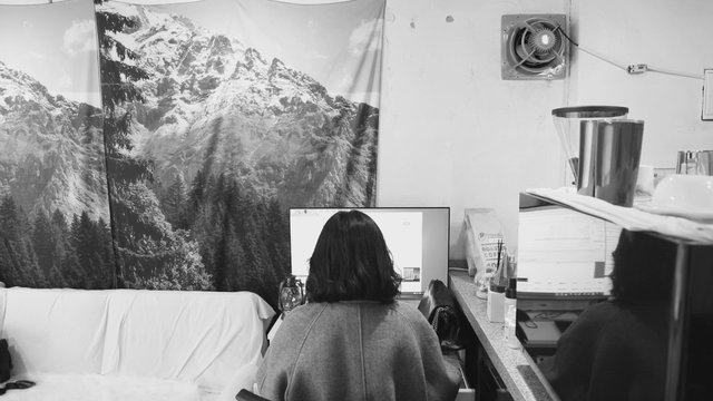 Person working at a desk in a cozy room