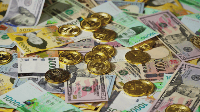 Various currencies and bitcoins scattered