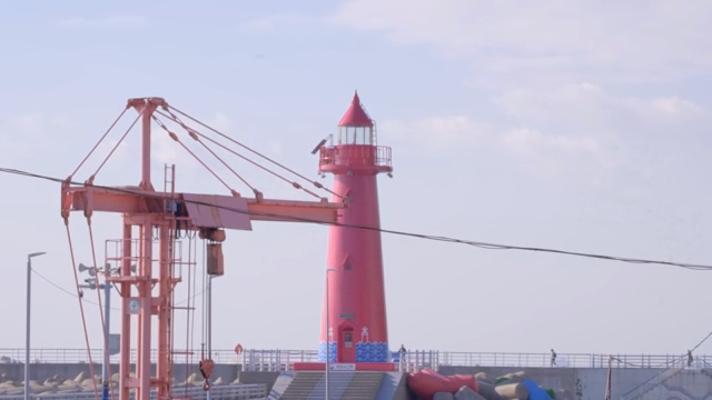 Vibrant red lighthouse by the sea