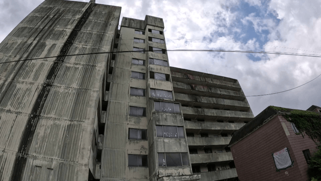 Old apartment building under cloudy sky