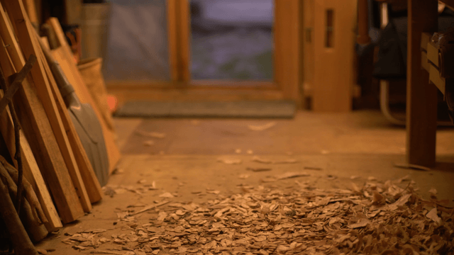 Scattered wooden pieces on workshop floor in rainy day
