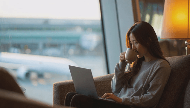 Woman enjoying coffee at an airport lounge