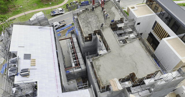 Workers pouring concrete on a building site