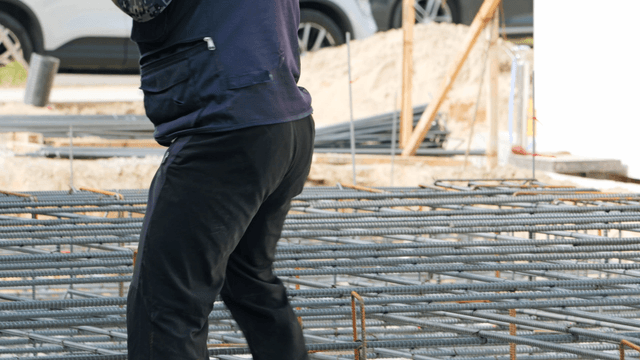 Construction workers handling rebar