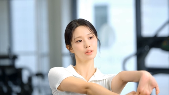 Woman stretching arms at gym