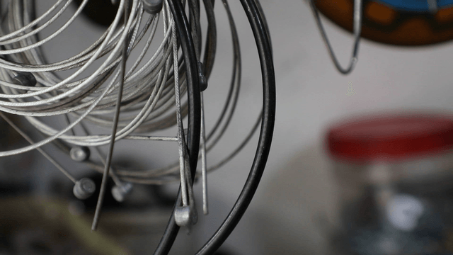 Coiled metal cables hanging in a workshop
