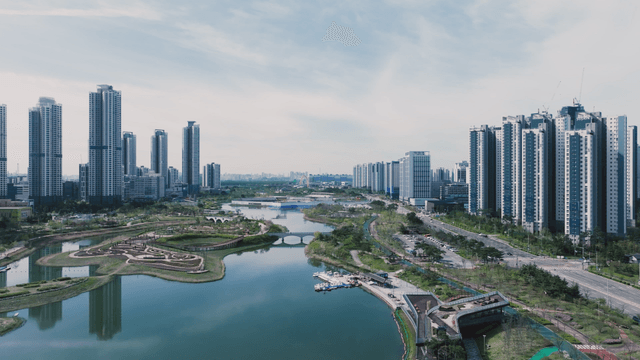 Modern cityscape with high-rise buildings and lake