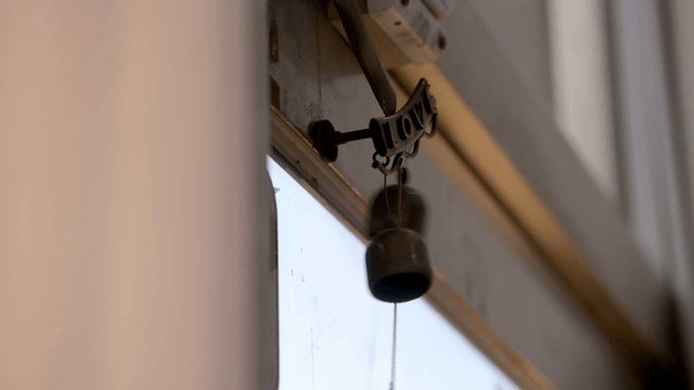 Small bell hanging by a window