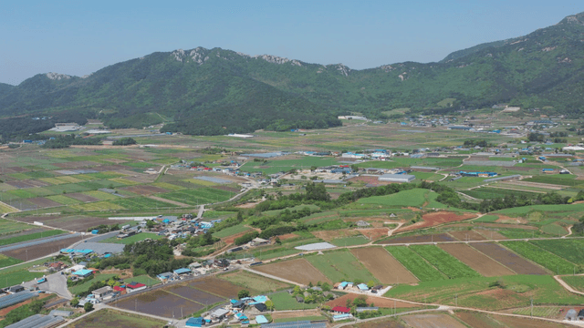 Expansive farmland with mountains in view