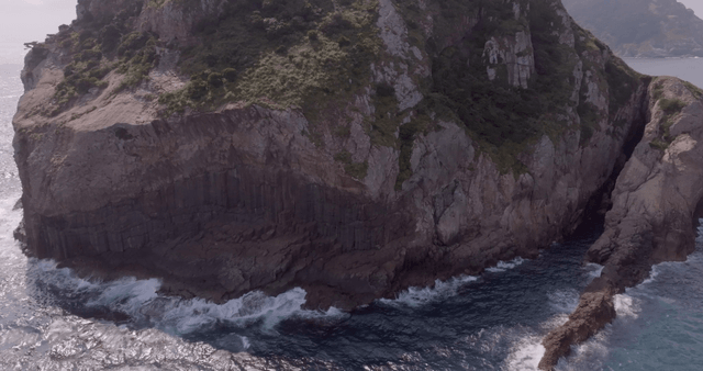 Rocky cliffside with waves crashing below