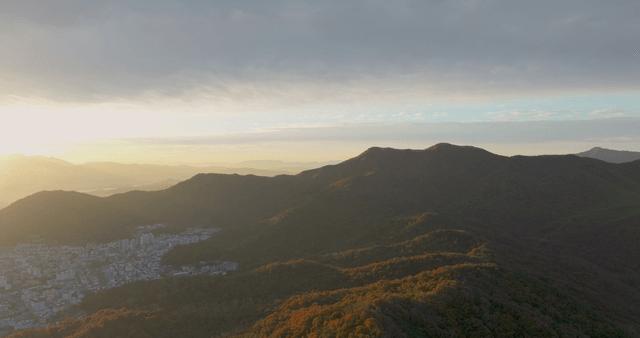 Sunrise over mountains and cityscape