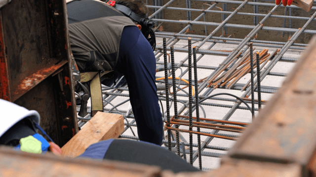 Construction workers assembling rebar