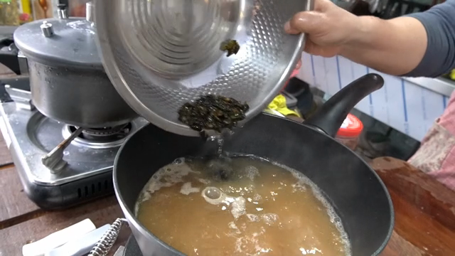 Pouring ingredients into a boiling pot