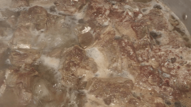 Meat boiling in a steaming pot