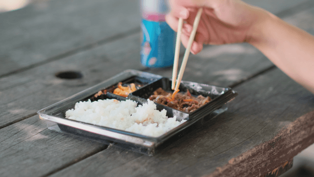 Eating a Korean lunchbox outdoors