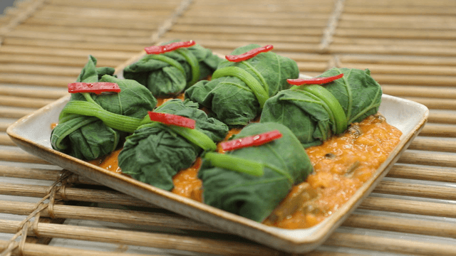 Pumpkin leaf wraps with rice in snail soybean paste sauce