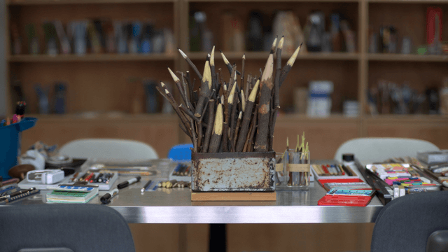Wooden branch pencil sculpture on art activity table