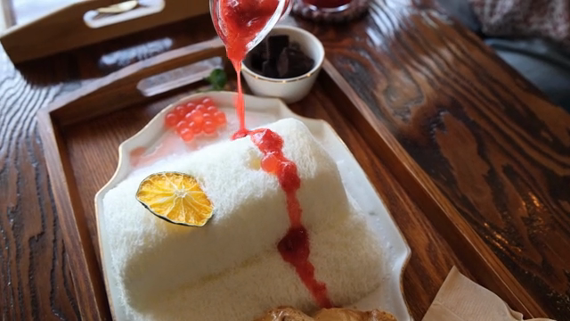 Strawberry preserves poured over shaved ice