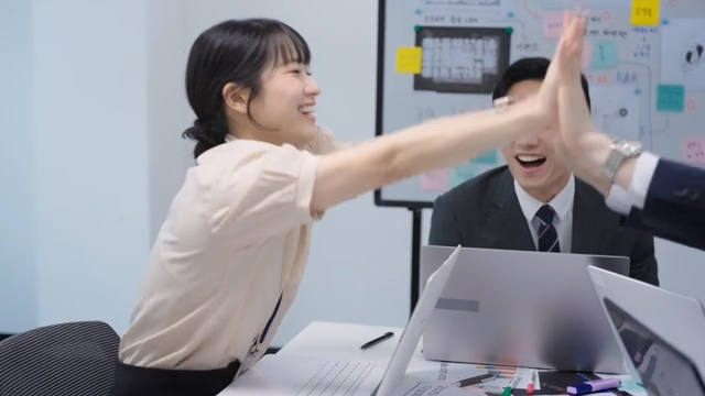 Team celebrating after confirming a deal over the phone