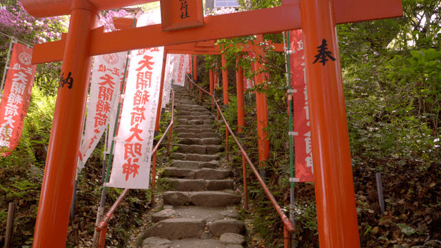 Stone steps passing through red torii gate at Japanese shrine