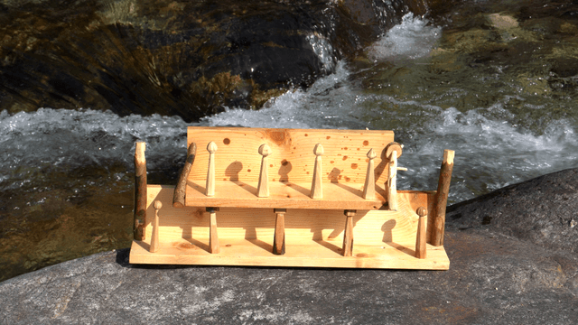 Wooden shelf beside a flowing river