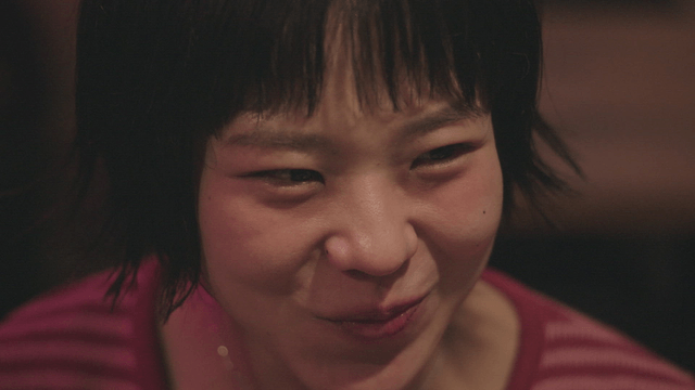 Woman talking while drinking soju