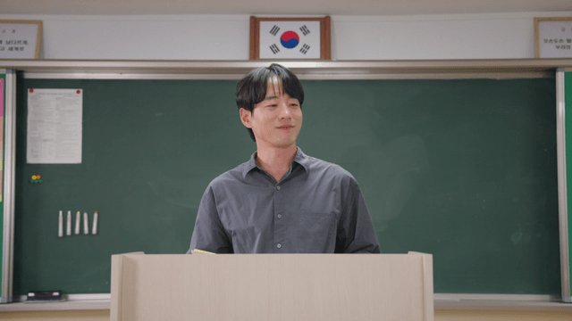 Teacher holding exam papers and praising students