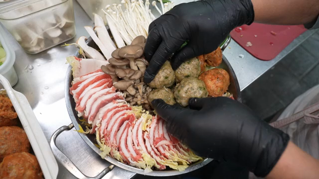 Preparing a hot pot with various ingredients