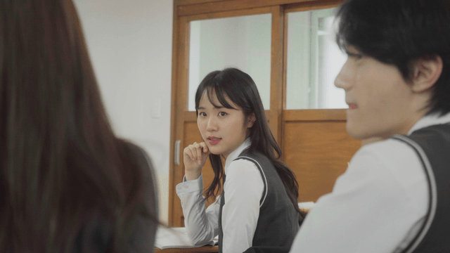Student chatting with classmates in the back
