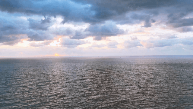 Clouded sky over a wide sea