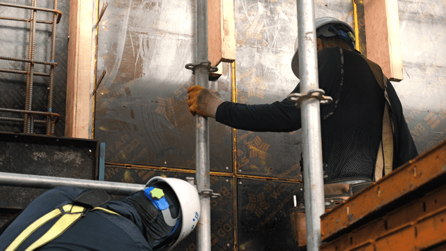 Construction workers assembling scaffolding