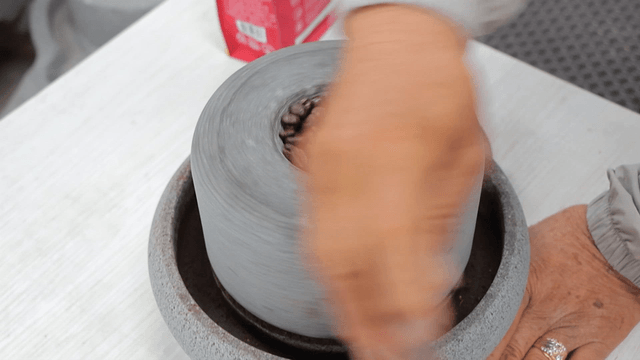 Traditional basalt millstone grinding coffee beans