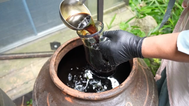 Soy sauce being poured into a glass bottle