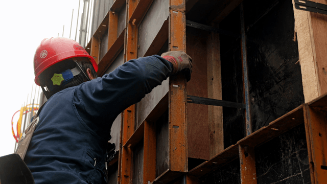 Construction worker assembling a framework