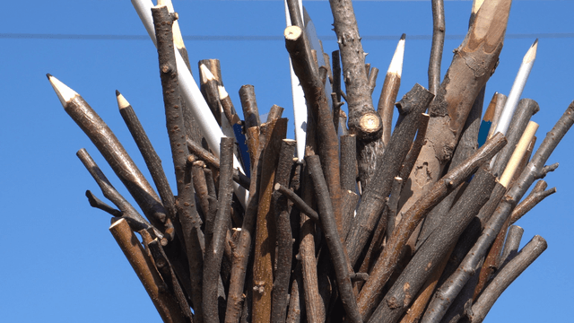 Wooden pencil sculpture under the clear sky