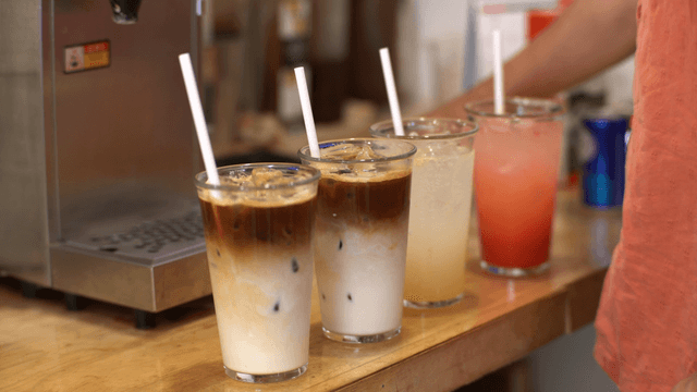 Various iced drinks on a wooden counter
