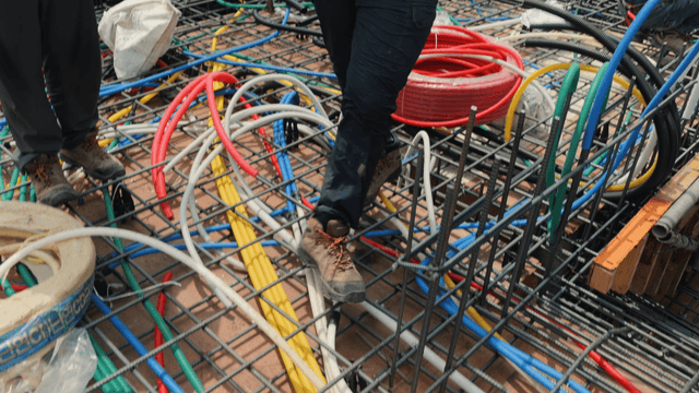 Workers installing cables at a construction site