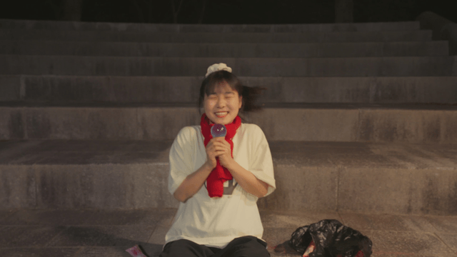 Girl dancing happily while holding an ice cream
